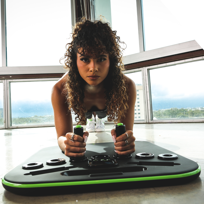 Person doing a plank exercise on a balance board indoors.